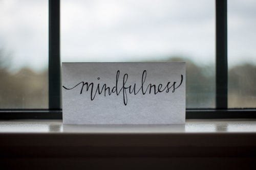 mindfulness-written-in-cursive-on-paper-near-window